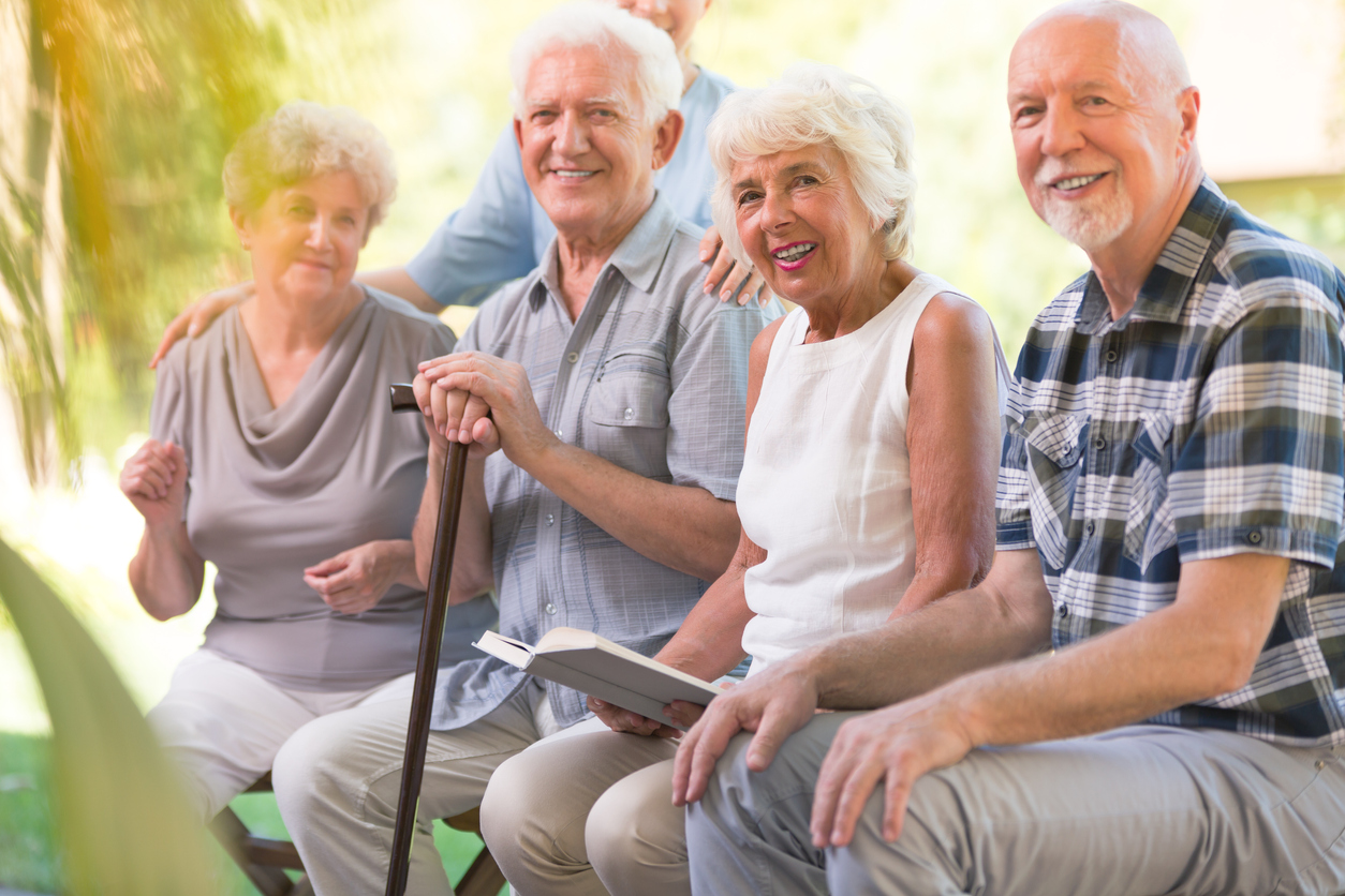 Smiling elderly people at patio Group of residents smiling at the camera